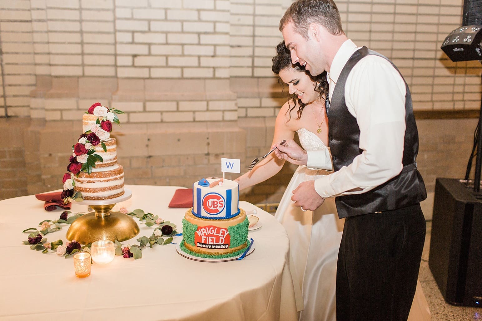 Arielle Peters Photography | Bride and groom cutting wedding cake at wedding reception at Baker Street Train Station in Fort Wayne, Indiana.