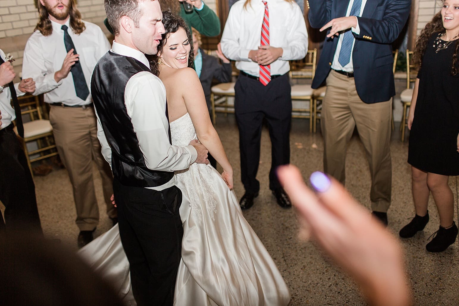 Arielle Peters Photography | Bride and groom laughing and dancing at wedding reception at Baker Street Train Station in Fort Wayne, Indiana.