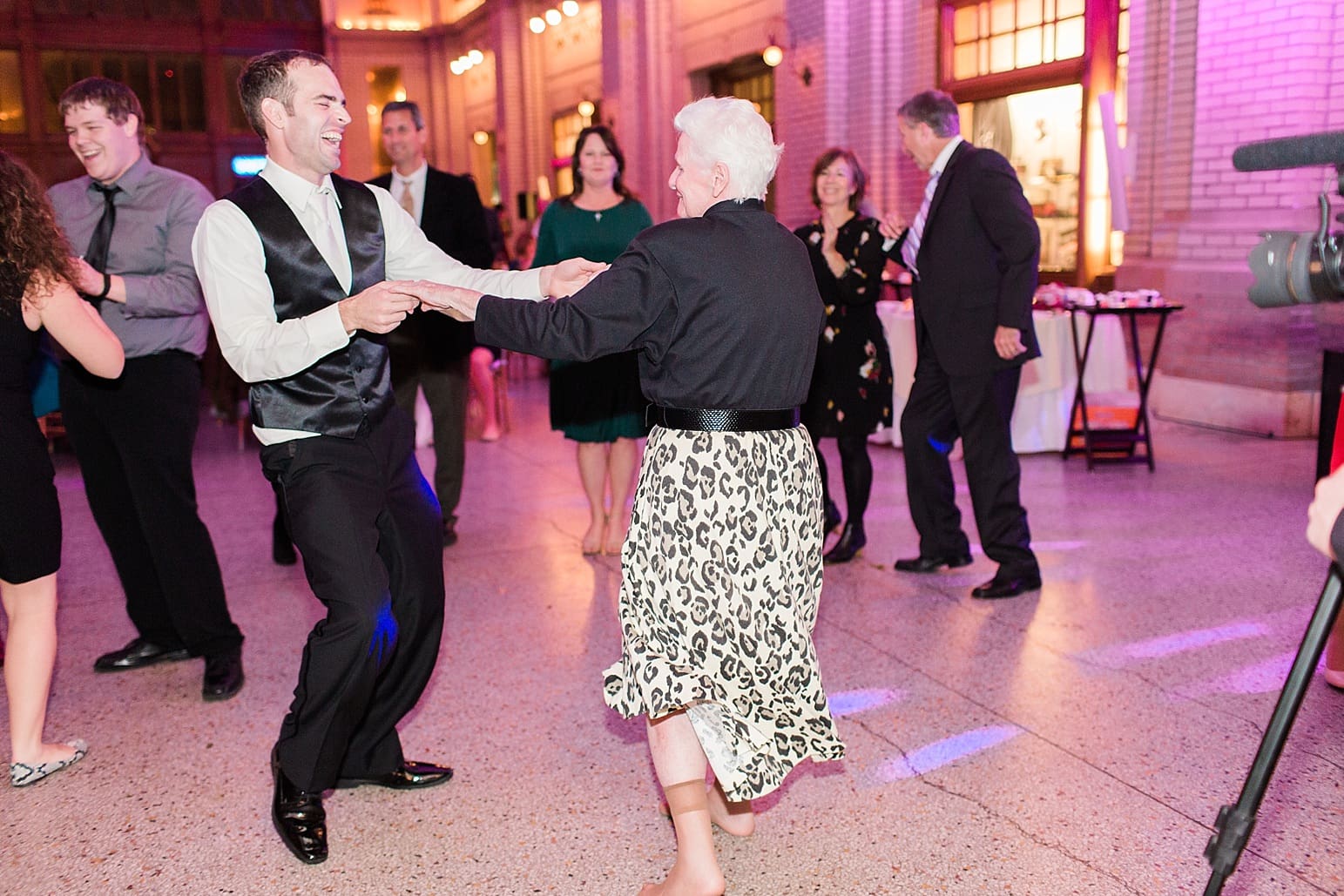 Arielle Peters Photography | Bride and groom laughing and dancing at wedding reception at Baker Street Train Station in Fort Wayne, Indiana.