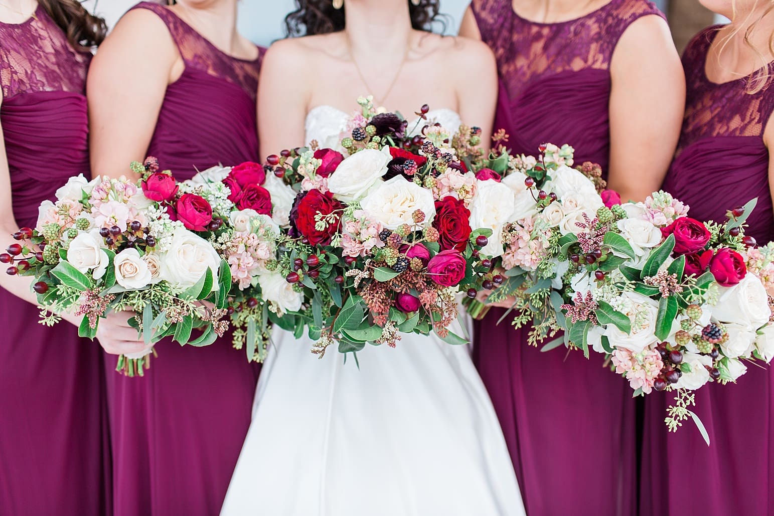 Arielle Peters Photography | Bride and bridesmaids holding bouquets outside train station on wedding day at Baker Street Train Station in Fort Wayne, Indiana.