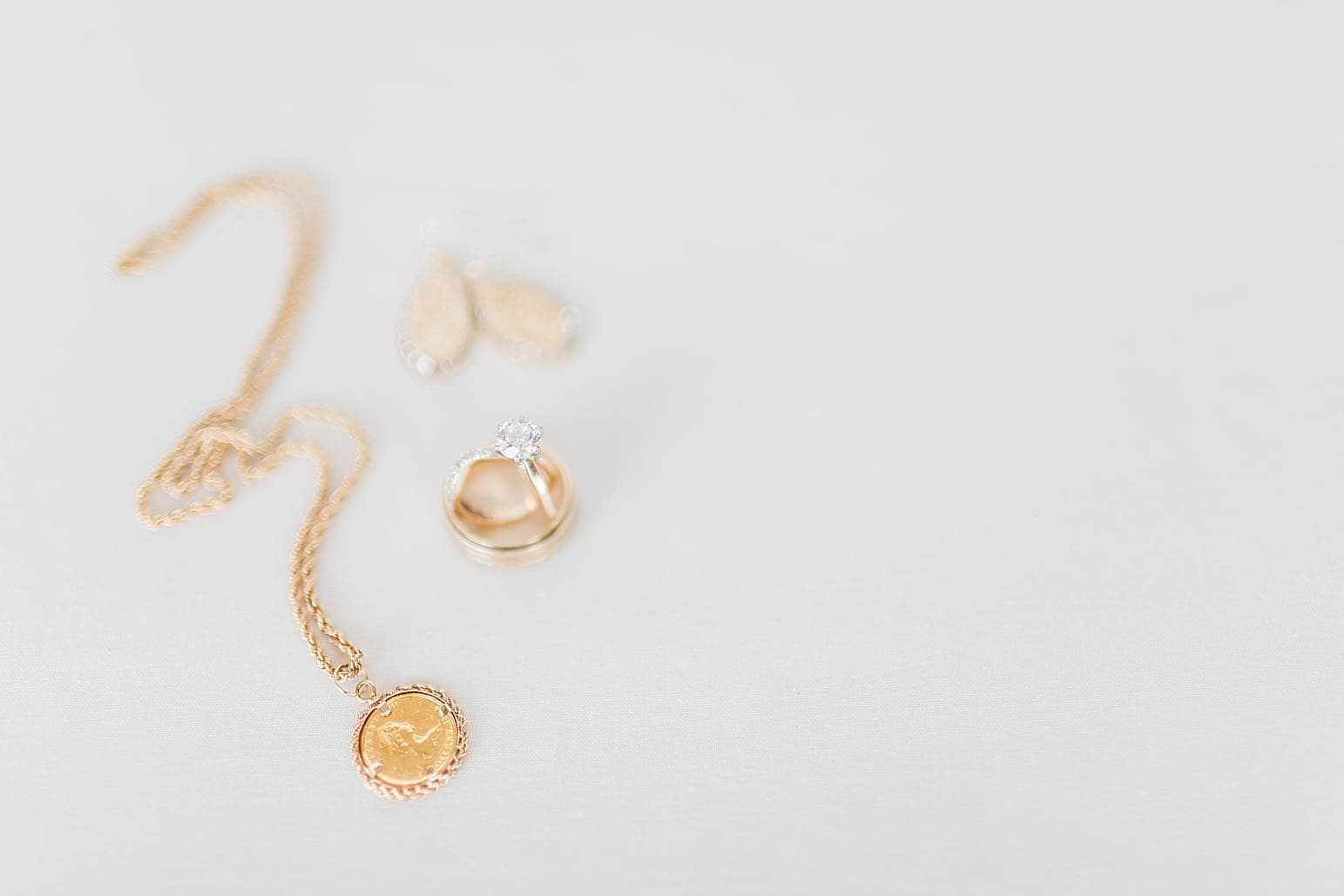 Arielle Peters Photography | Wedding rings and jewelry on wedding day at Baker Street Train Station in Fort Wayne, Indiana.