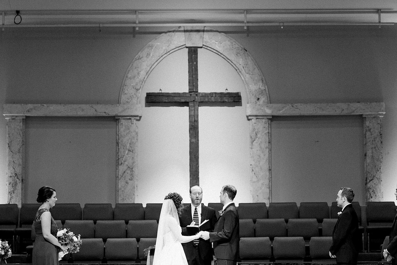 Arielle Peters Photography | Bride and groom standing at the alter on wedding day at Baker Street Train Station in Fort Wayne, Indiana.