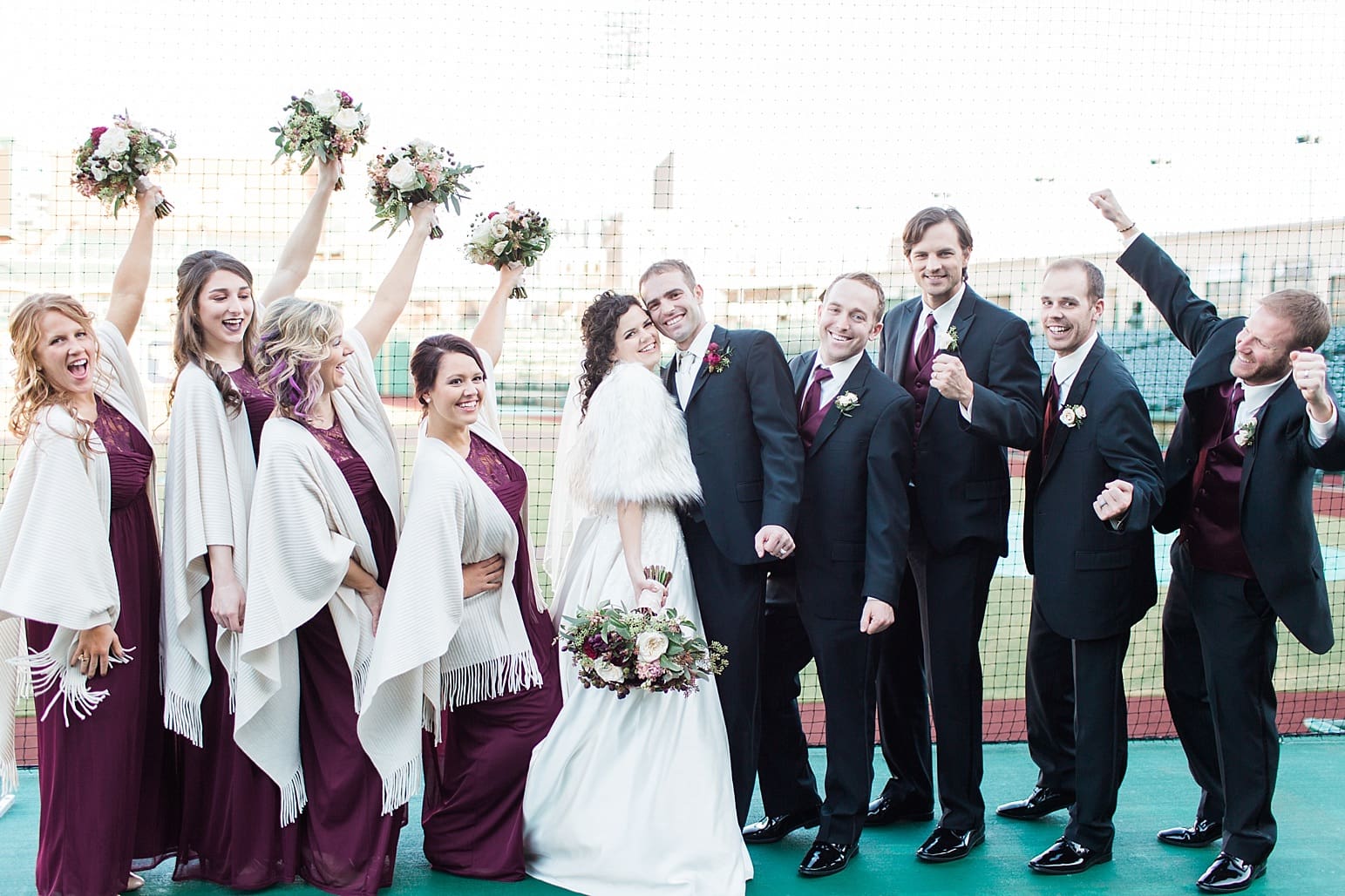 Arielle Peters Photography | Wedding party cheering at Parkview Field on wedding day in Fort Wayne, Indiana.