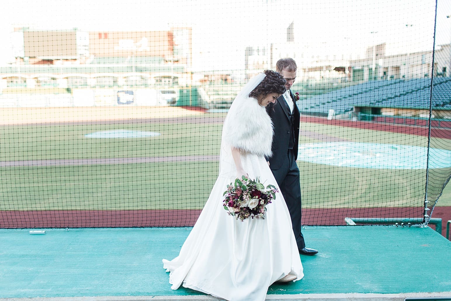 Arielle Peters Photography | Bride and groom walking at Parkview Field on wedding day in Fort Wayne, Indiana.