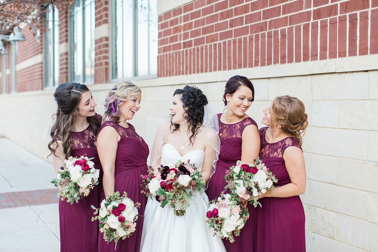 Arielle Peters Photography | Bride and bridesmaids on city streets on wedding day at Baker Street Train Station in Fort Wayne, Indiana.