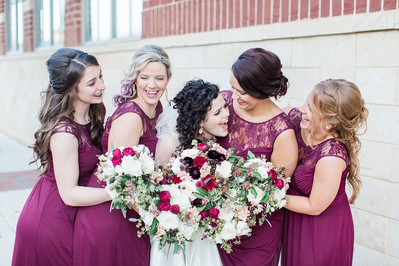 Arielle Peters Photography | Bride and bridesmaids on city streets on wedding day at Baker Street Train Station in Fort Wayne, Indiana.