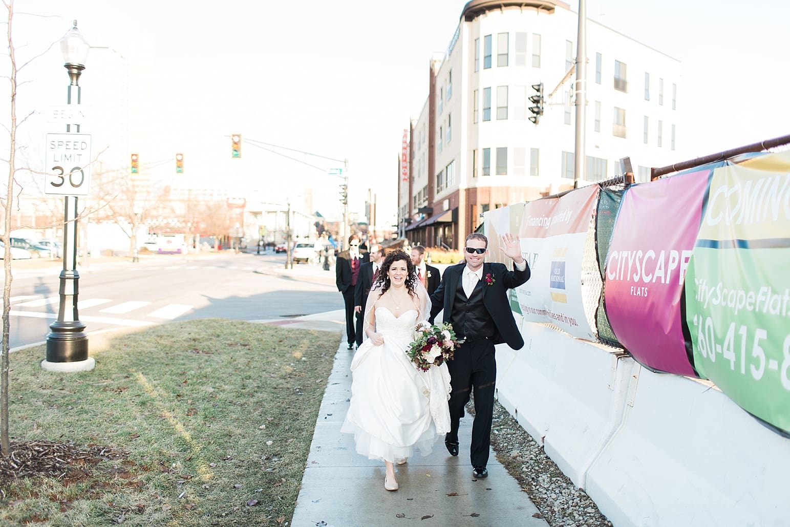 Arielle Peters Photography | Wedding party walking on city streets on wedding day at Baker Street Train Station in Fort Wayne, Indiana.