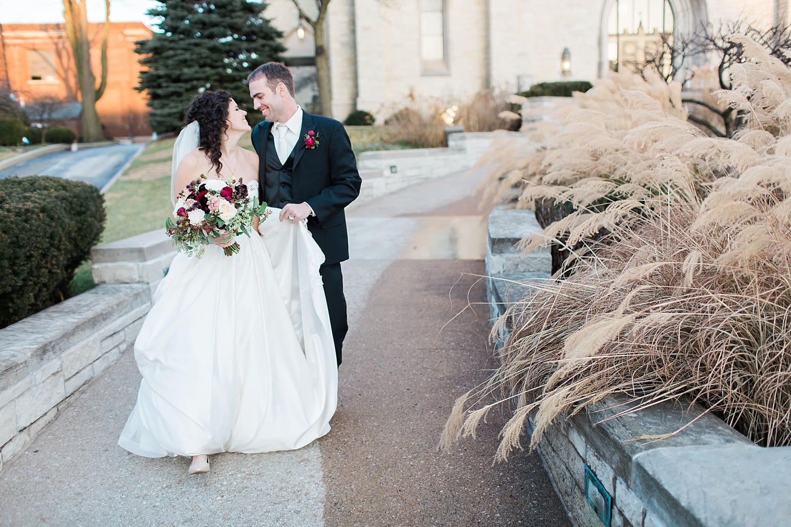 Arielle Peters Photography | Bride and groom walking outside train station on wedding day at Baker Street Train Station in Fort Wayne, Indiana.
