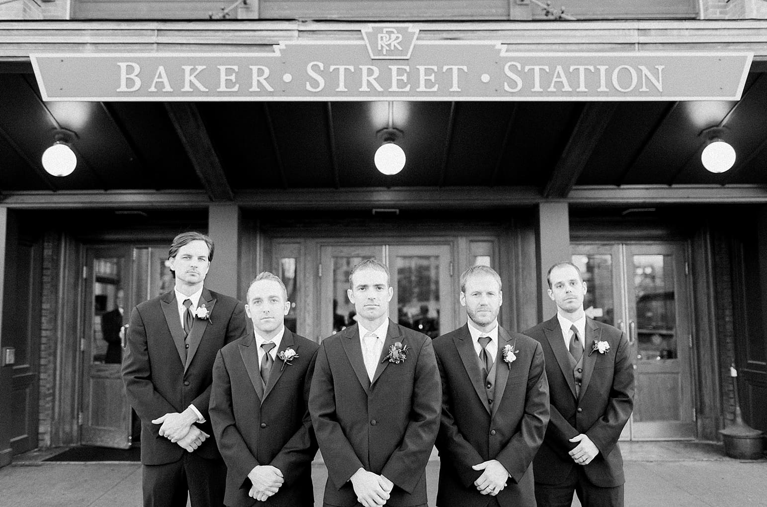 Arielle Peters Photography | Groom and groomsmen on wedding day outside Baker Street Train Station in Fort Wayne, Indiana.