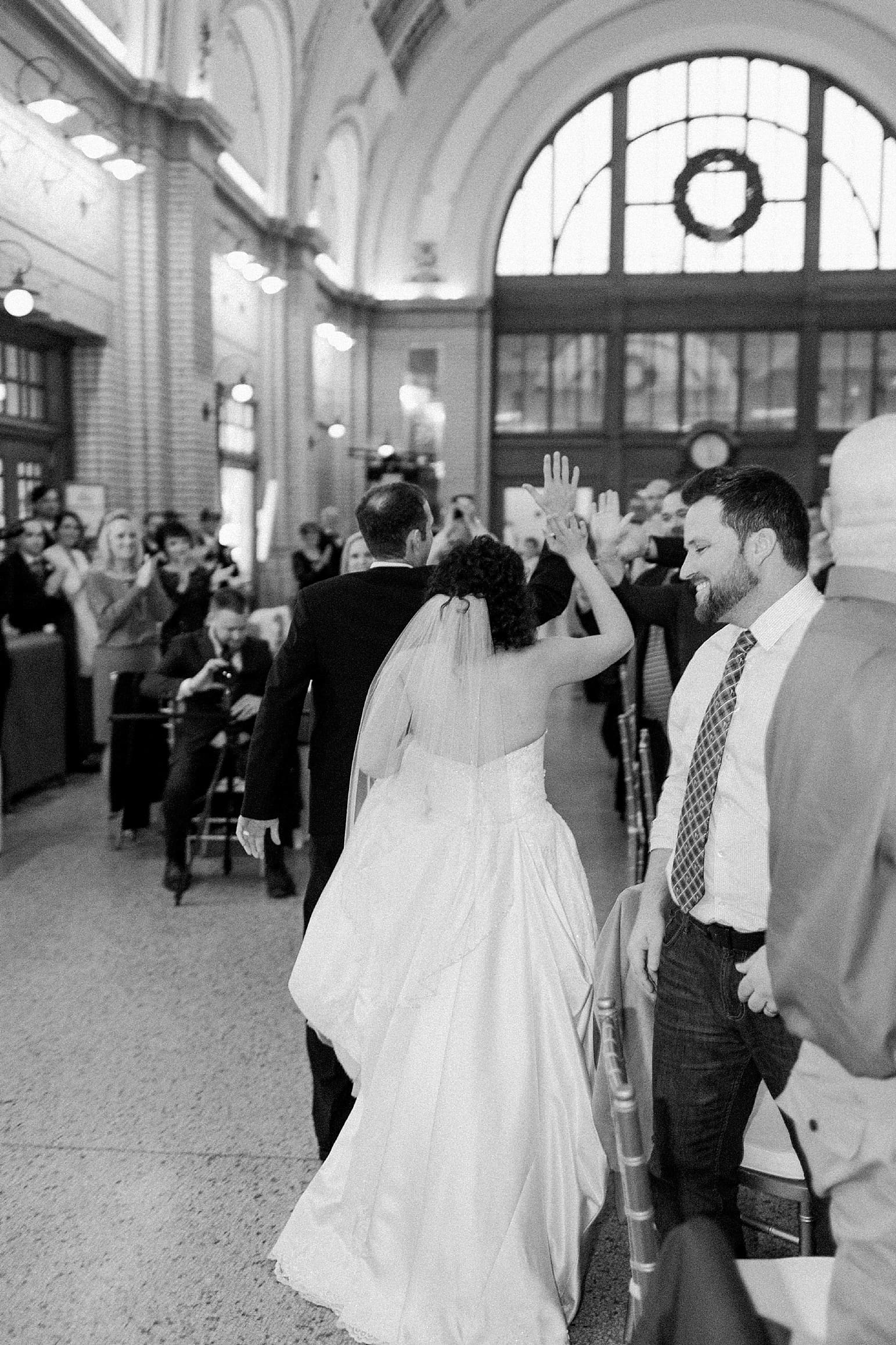 Arielle Peters Photography | Bride and groom entering wedding reception at Baker Street Train Station in Fort Wayne, Indiana.