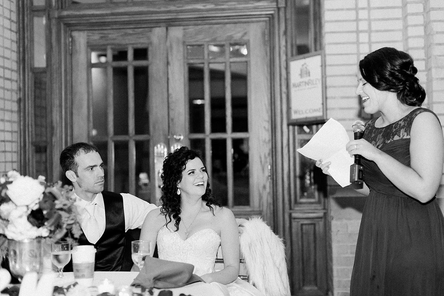 Arielle Peters Photography | Maid of honor giving toast at wedding reception at Baker Street Train Station in Fort Wayne, Indiana.
