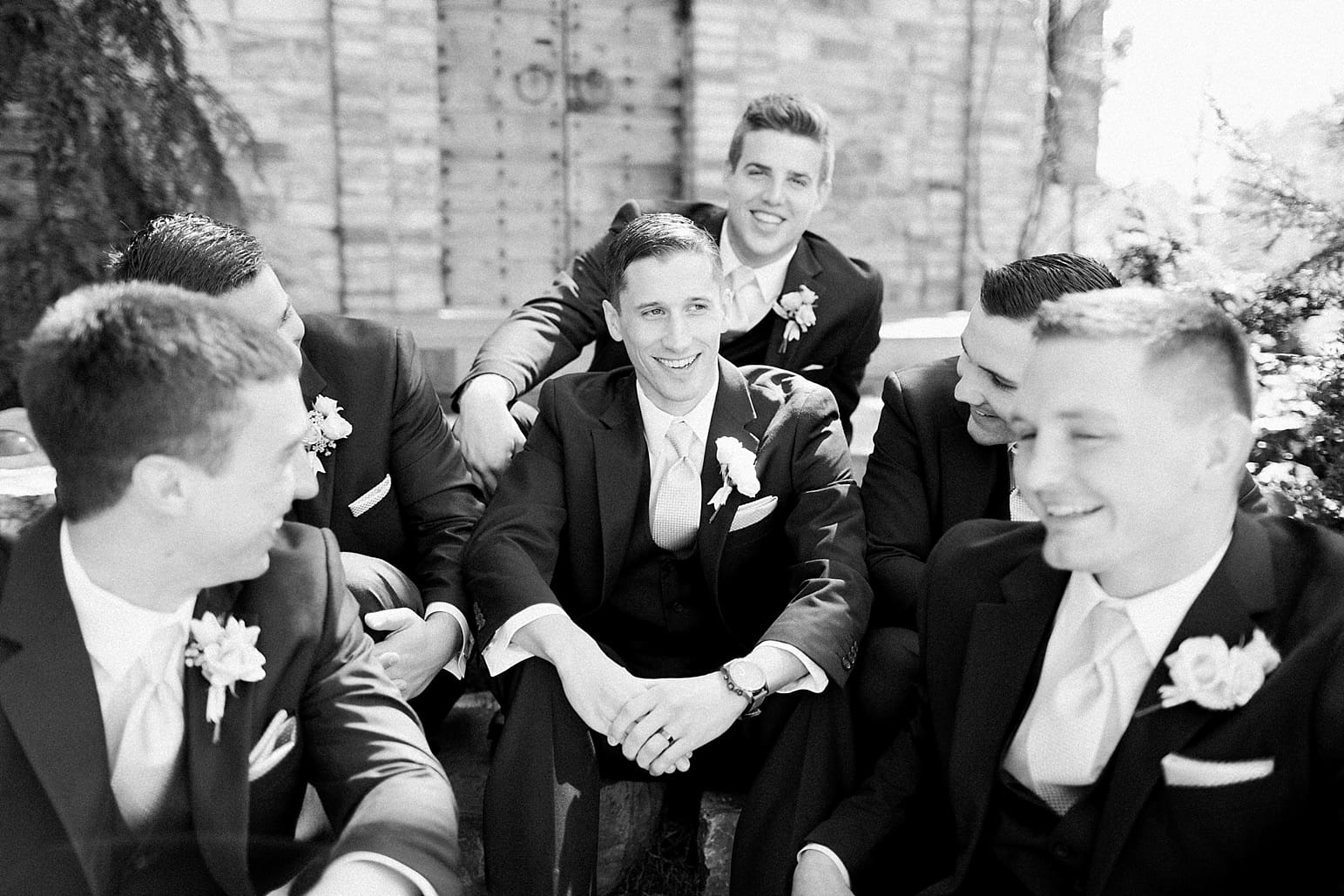Arielle Peters Photography | Groom and groomsmen sitting on old stone steps on wedding day at The Market in Valparaiso, Indiana.