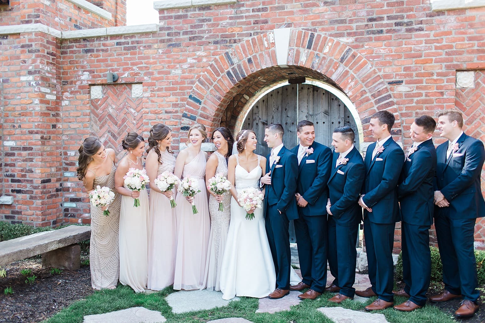 Arielle Peters Photography | Wedding party in front of brick archway on wedding day at The Market in Valparaiso, Indiana.