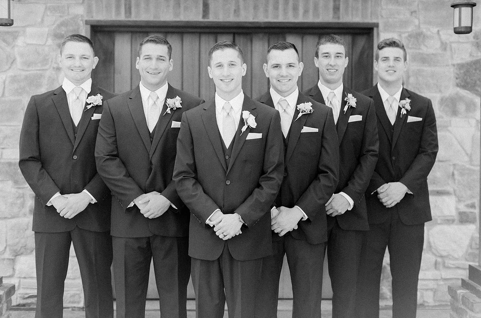 Arielle Peters Photography | Groom and groomsmen in front of old wood doors on wedding day at The Market in Valparaiso, Indiana.