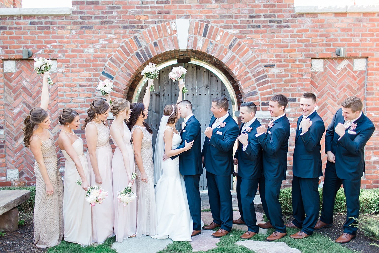 Arielle Peters Photography | Bride and groom kissing under old brick archway on wedding day at The Market in Valparaiso, Indiana.