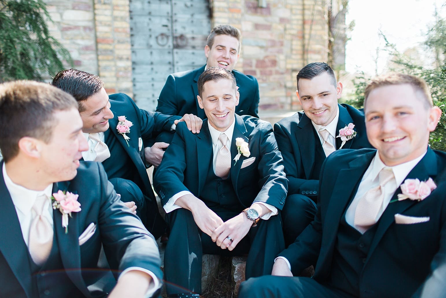 Arielle Peters Photography | Groom and groomsmen sitting on stone steps on wedding day at The Market in Valparaiso, Indiana.