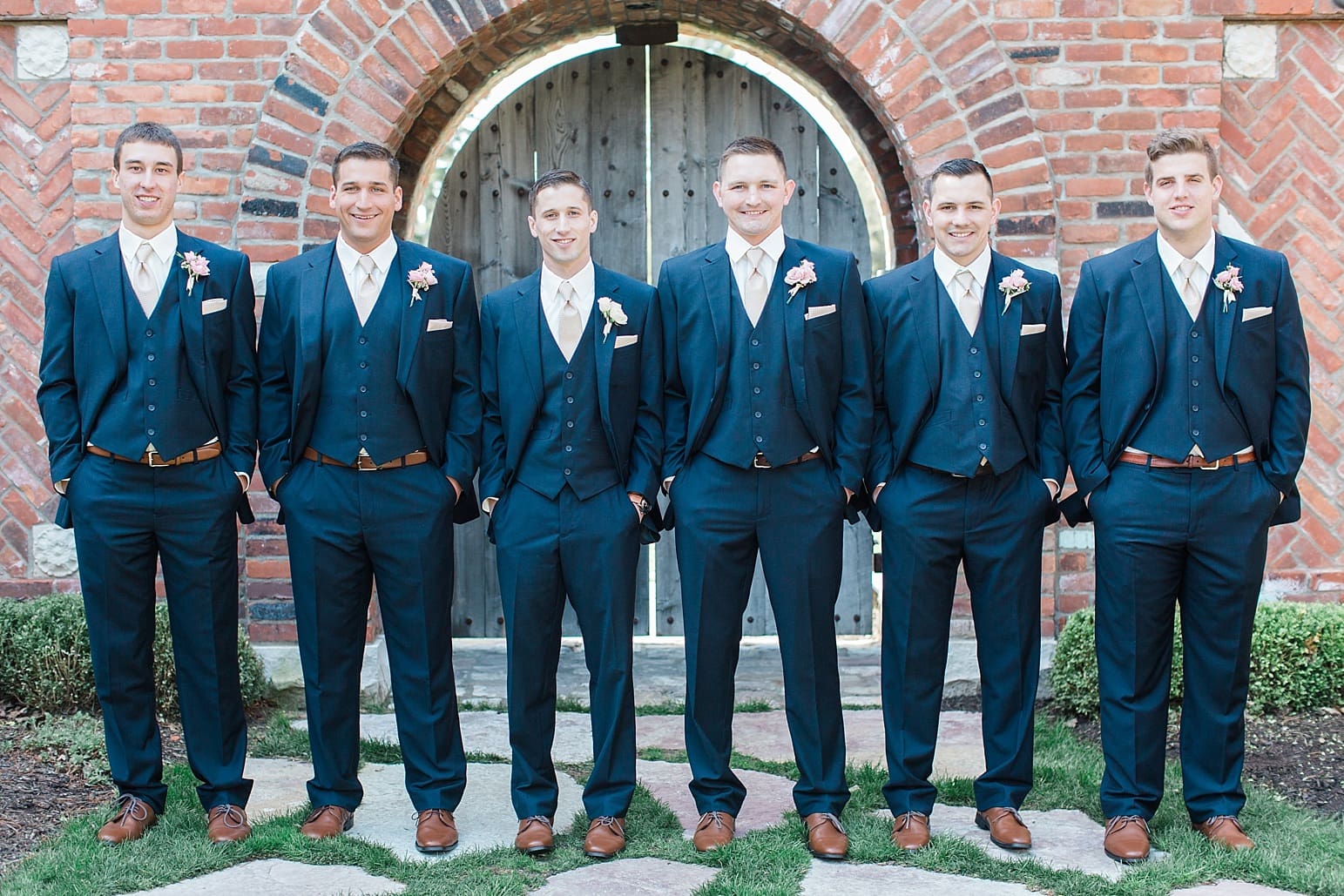 Arielle Peters Photography | Groom and groomsmen in front of old brick archway on wedding day at The Market in Valparaiso, Indiana.