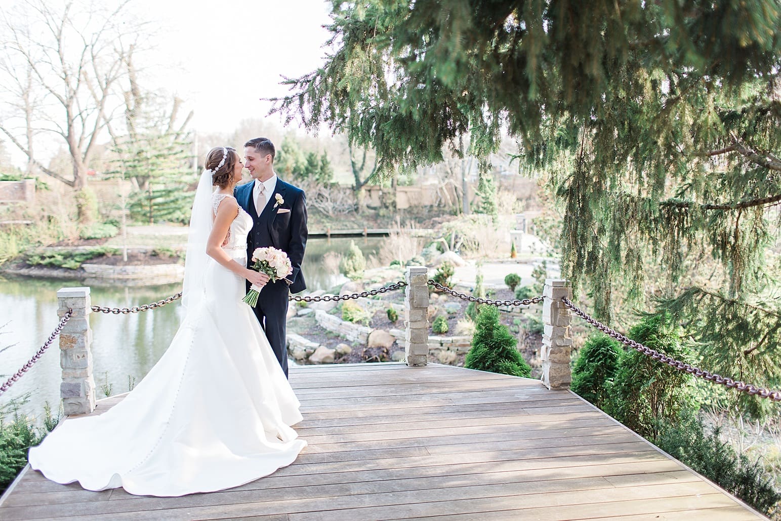 Arielle Peters Photography | Bride and groom next to hidden garden pond on wedding day at The Market in Valparaiso, Indiana.
