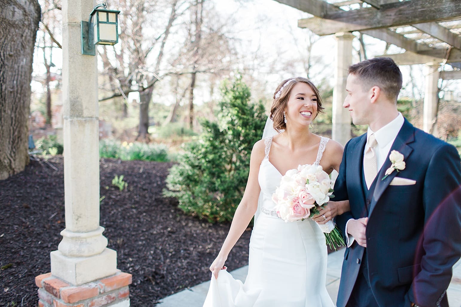 Arielle Peters Photography | Bride and groom walking under long wooden pergola on wedding day at The Market in Valparaiso, Indiana.