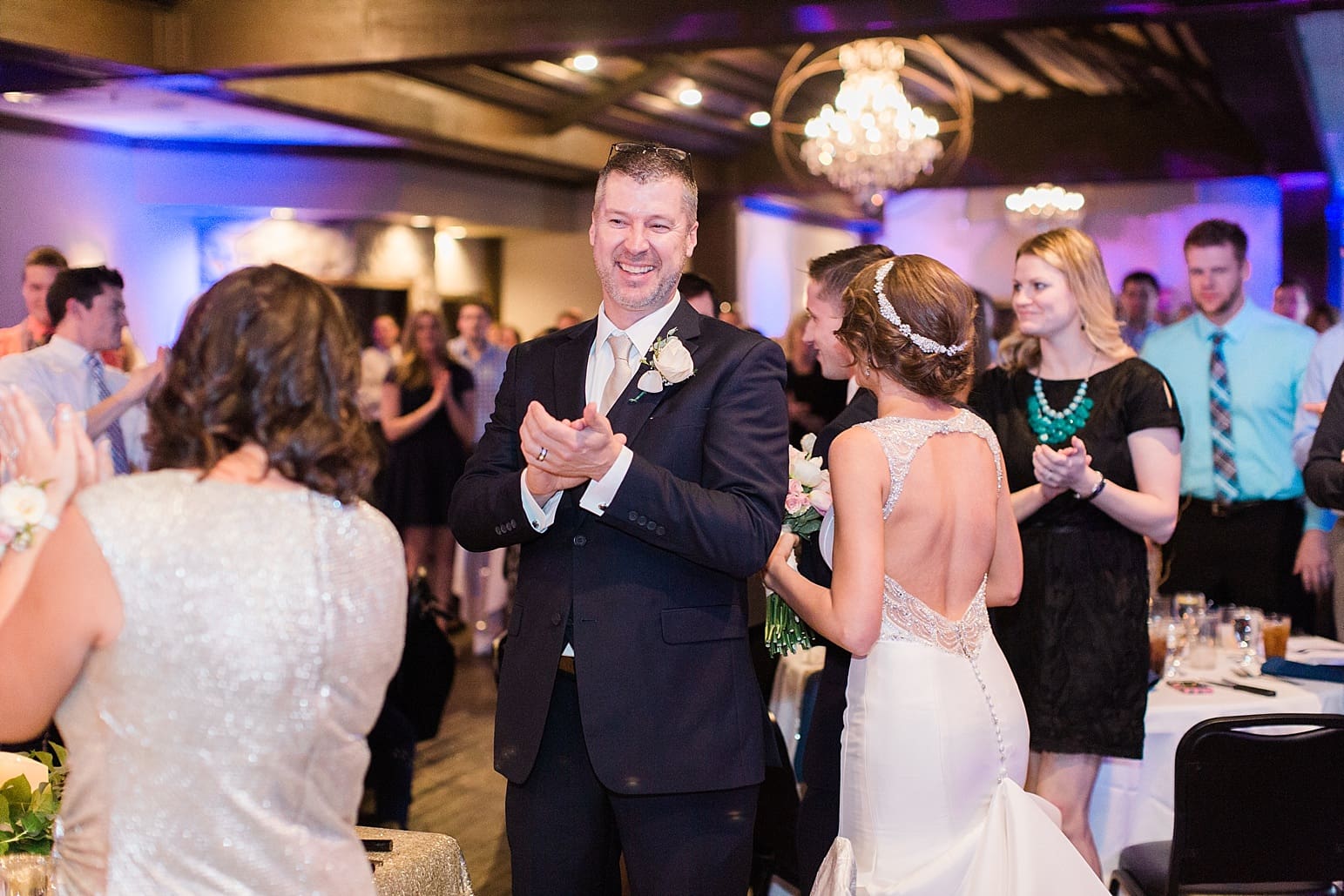 Arielle Peters Photography | Wedding guests cheering at wedding reception at The Market in Valparaiso, Indiana.