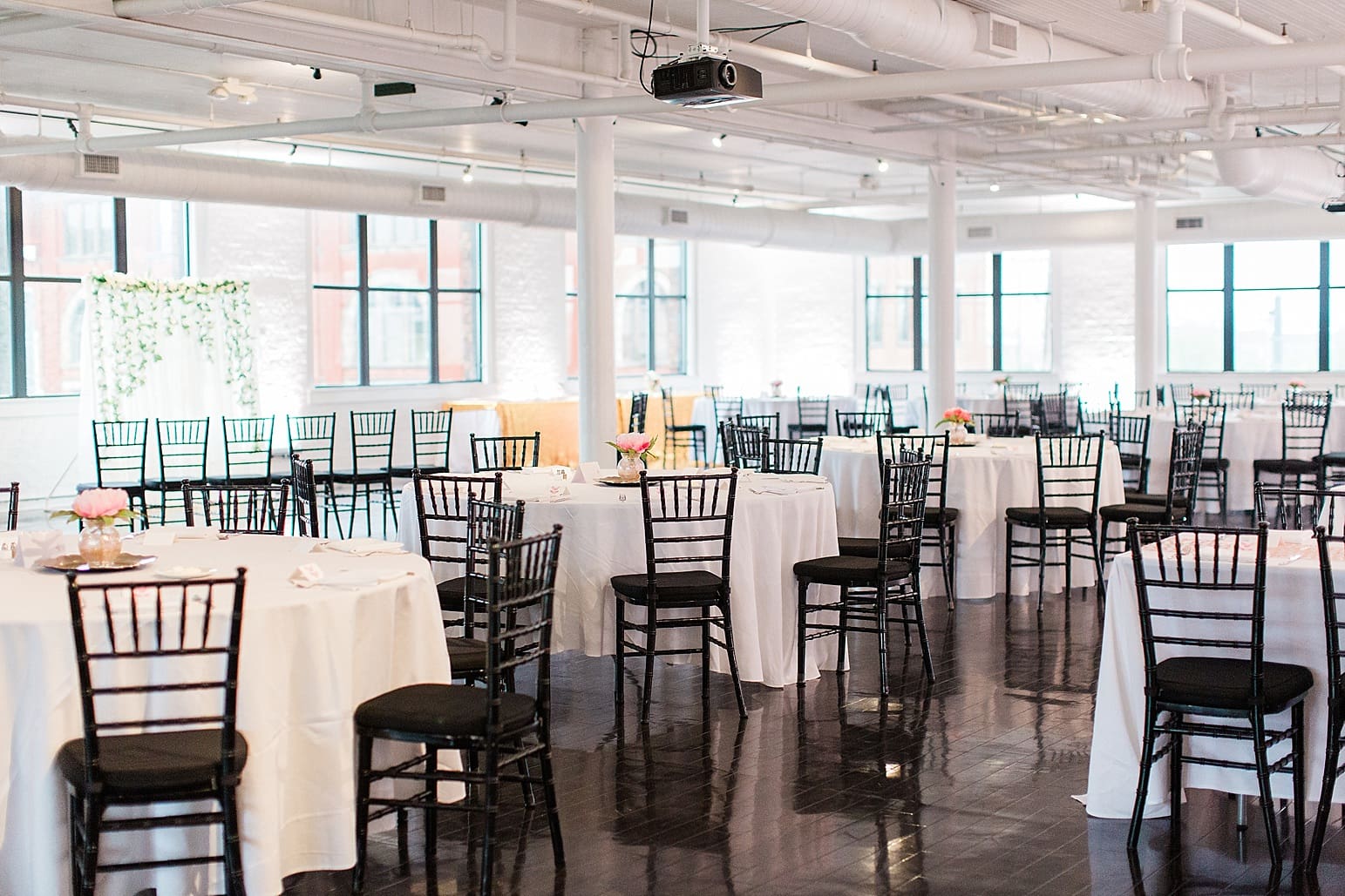 Arielle Peters Photography | Wedding reception table settings and floral arrangements on wedding day at Loft 310 in Kalamazoo, Michigan.