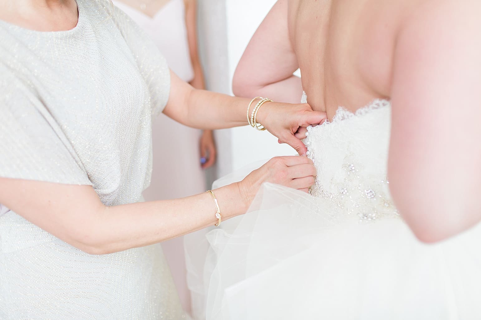 Arielle Peters Photography | Mother of bride helping bride put on dress on wedding day at Loft 310 in Kalamazoo, Michigan.