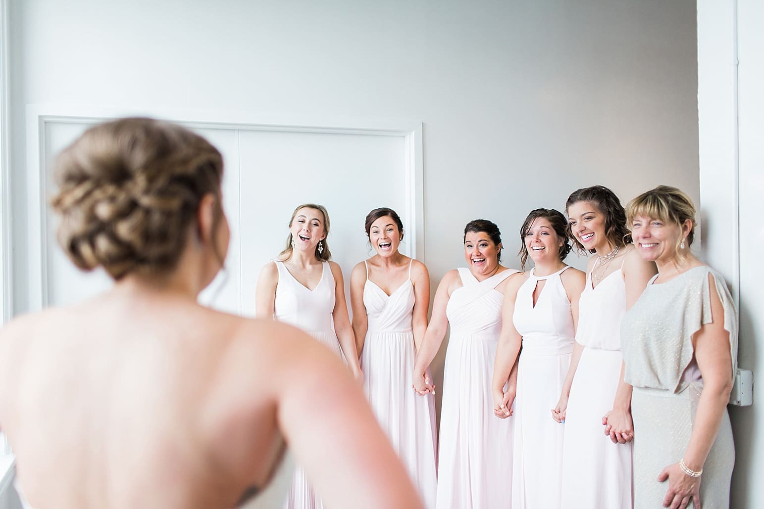 Arielle Peters Photography | Bride and bridesmaids having first reveal on wedding day at Loft 310 in Kalamazoo, Michigan.