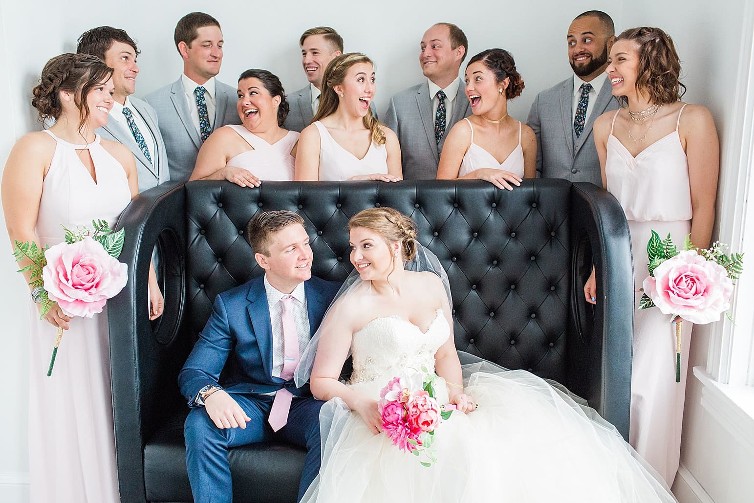 Arielle Peters Photography | Wedding party next to large loft window on wedding day at Loft 310 in Kalamazoo, Michigan.
