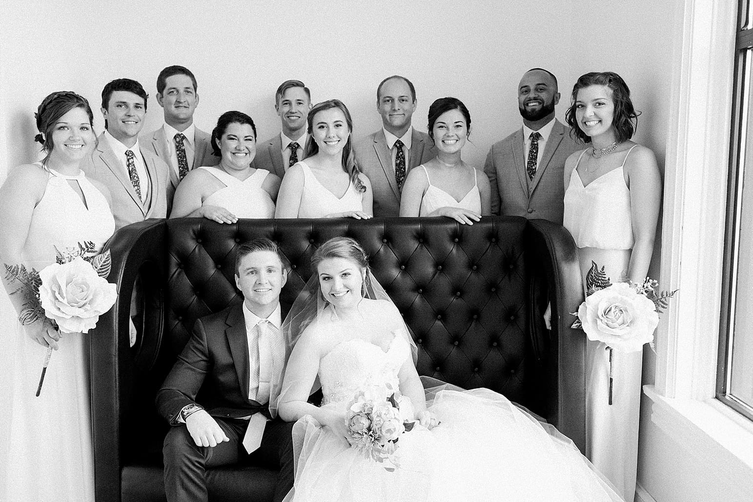 Arielle Peters Photography | Wedding party next to large loft window on wedding day at Loft 310 in Kalamazoo, Michigan.