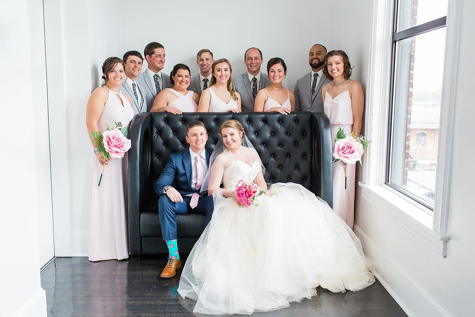 Arielle Peters Photography | Wedding party next to large loft windows on wedding day at Loft 310 in Kalamazoo, Michigan.