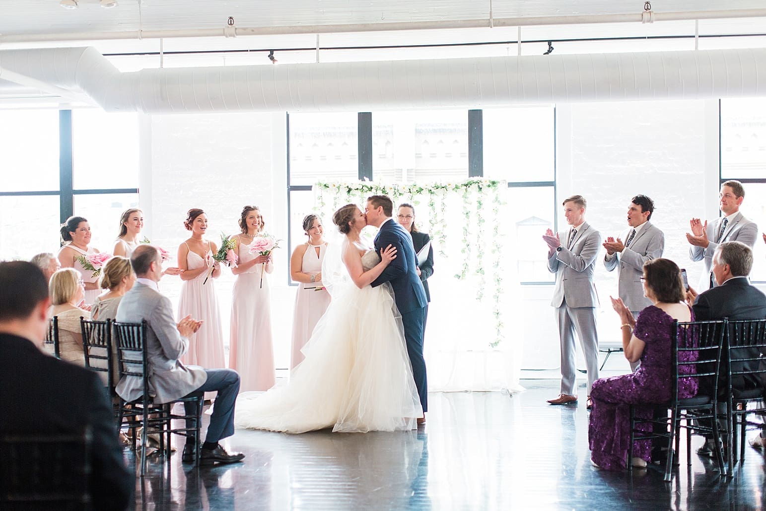 Arielle Peters Photography | Bride and groom kissing at the alter on wedding day at Loft 310 in Kalamazoo, Michigan.