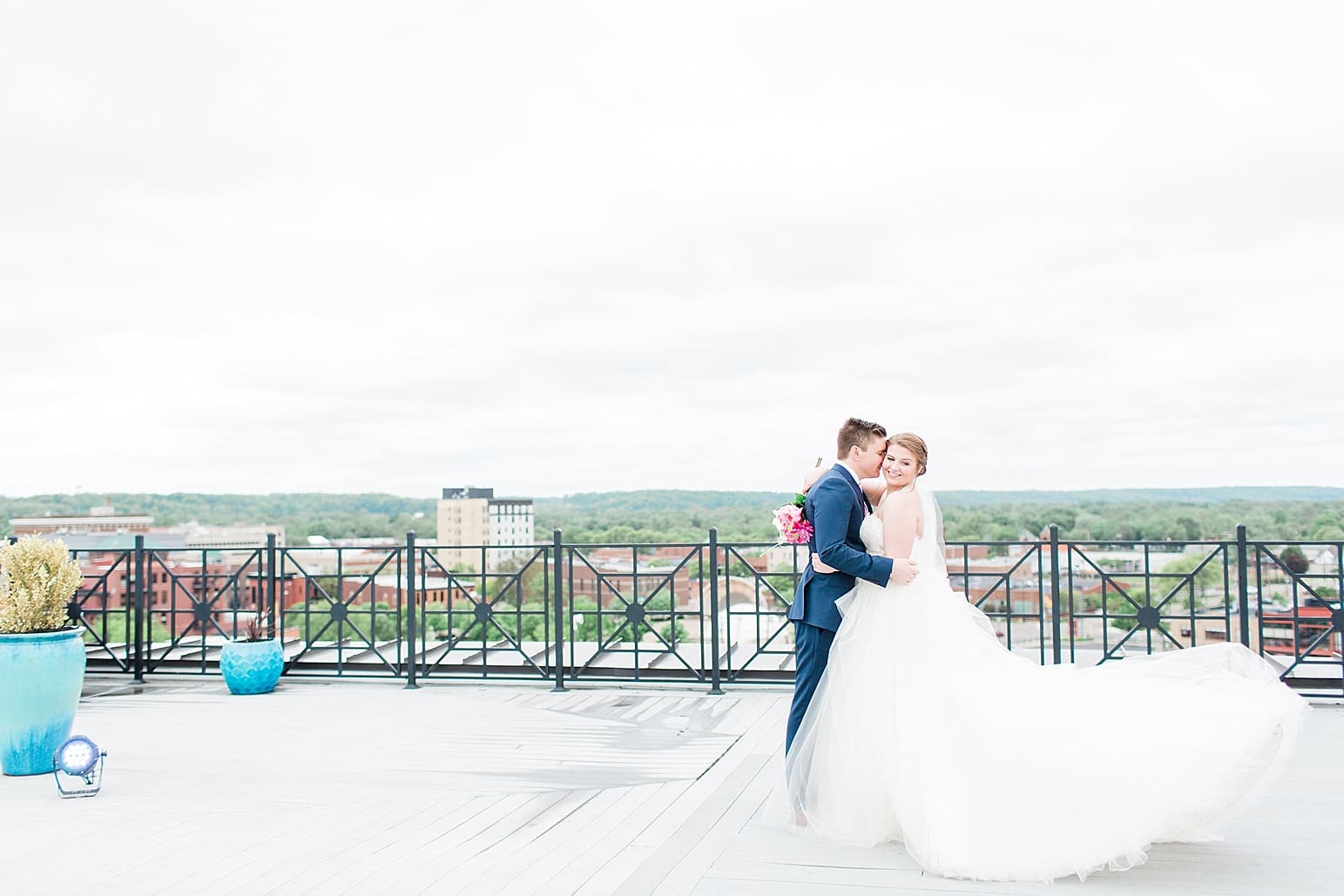 Arielle Peters Photography | Bride and groom on rooftop terrace overlooking the city on wedding day at Loft 310 in Kalamazoo, Michigan.
