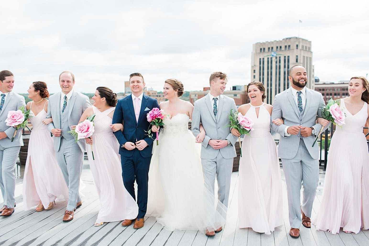 Arielle Peters Photography | Wedding party walking on rooftop terrace overlooking the city on wedding day at Loft 310 in Kalamazoo, Michigan.