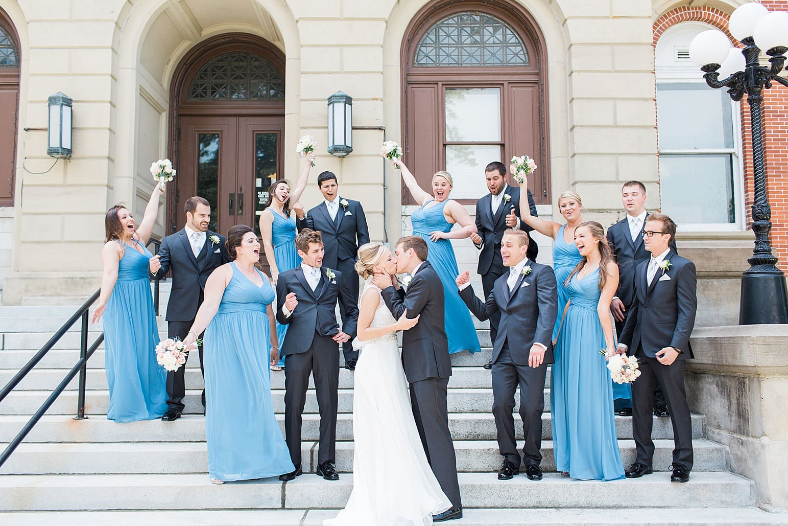 Arielle Peters Photography | Wedding party cheering on church steps on wedding day at the Spohn Ballroom in Goshen, Indiana.