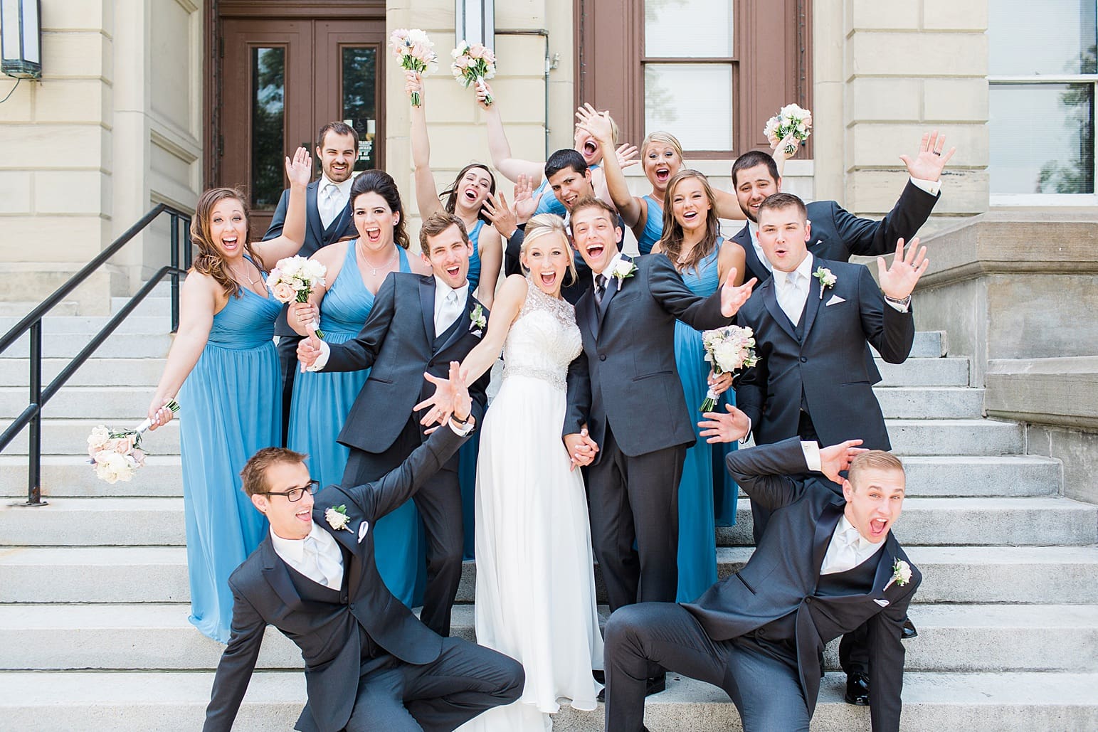 Arielle Peters Photography | Wedding party cheering on church steps on wedding day at the Spohn Ballroom in Goshen, Indiana.