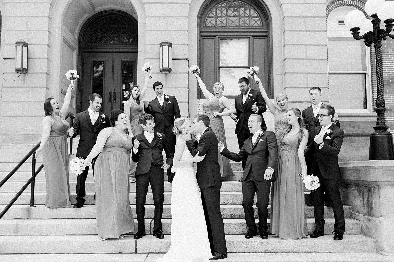 Arielle Peters Photography | Bride and groom kissing on church steps on wedding day at the Spohn Ballroom in Goshen, Indiana.