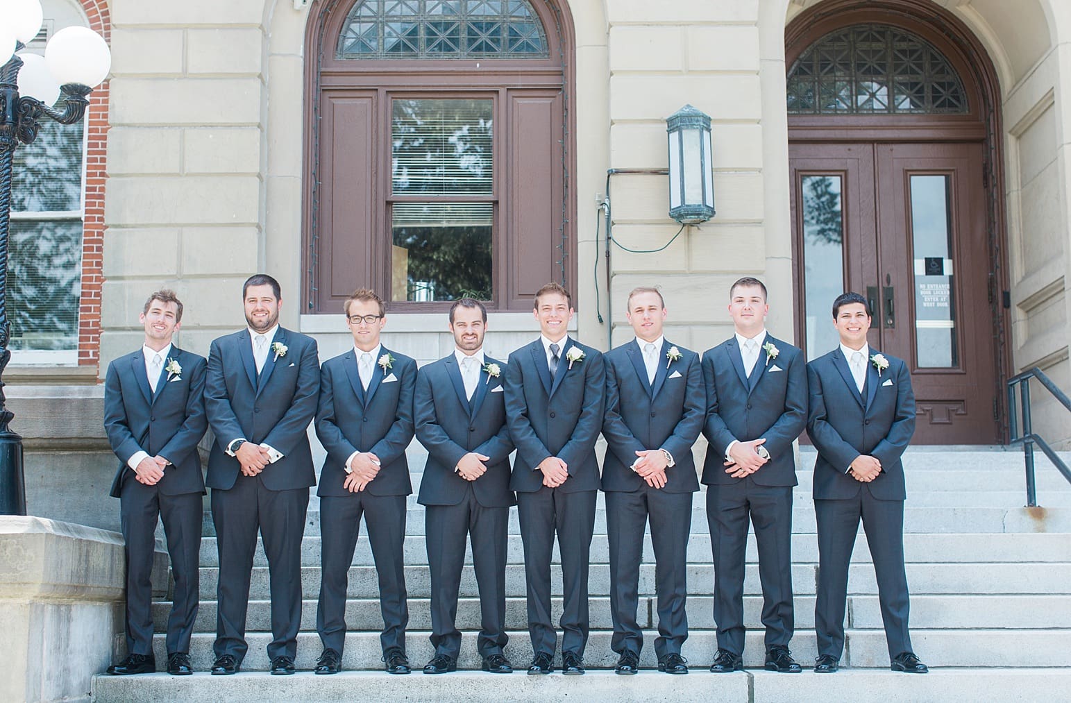 Arielle Peters Photography | Groom and groomsmen standing on church steps on wedding day at the Spohn Ballroom in Goshen, Indiana.