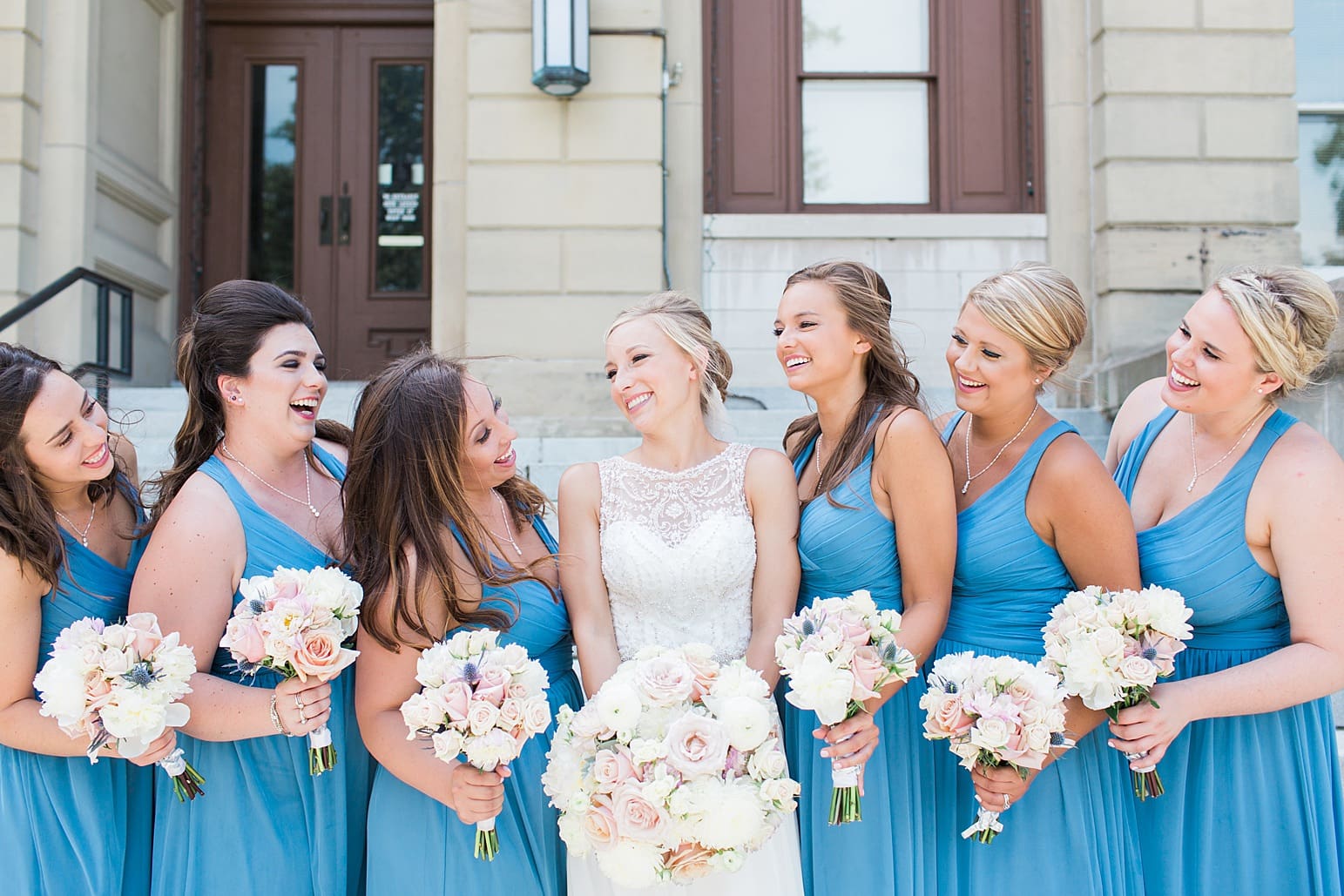 Arielle Peters Photography | Bride and bridesmaids on church steps on wedding day at the Spohn Ballroom in Goshen, Indiana.
