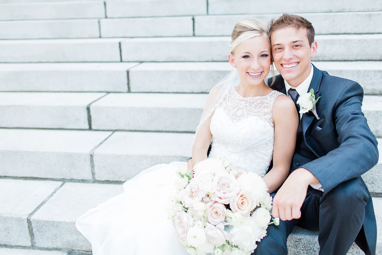 Arielle Peters Photography | Bride and groom sitting on church steps on wedding day at the Spohn Ballroom in Goshen, Indiana.