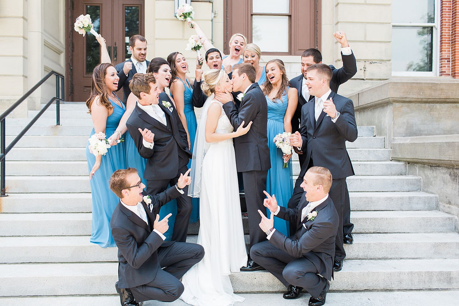 Arielle Peters Photography | Wedding party cheering on church steps on wedding day at the Spohn Ballroom in Goshen, Indiana.