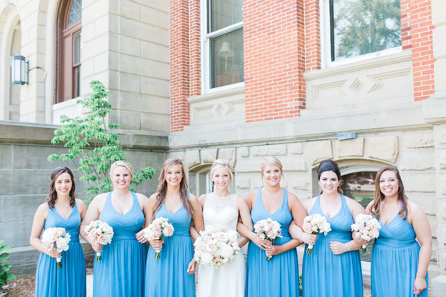 Arielle Peters Photography | Bride and bridesmaids outside brick church on wedding day at the Spohn Ballroom in Goshen, Indiana.