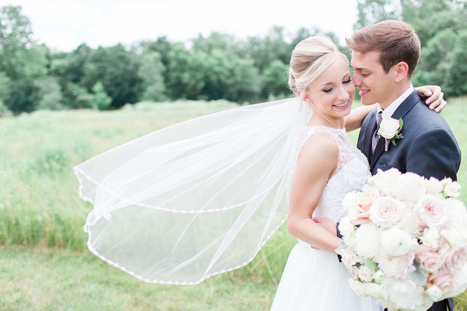 Arielle Peters Photography | Bride and groom in open field on wedding day at the Spohn Ballroom in Goshen, Indiana.