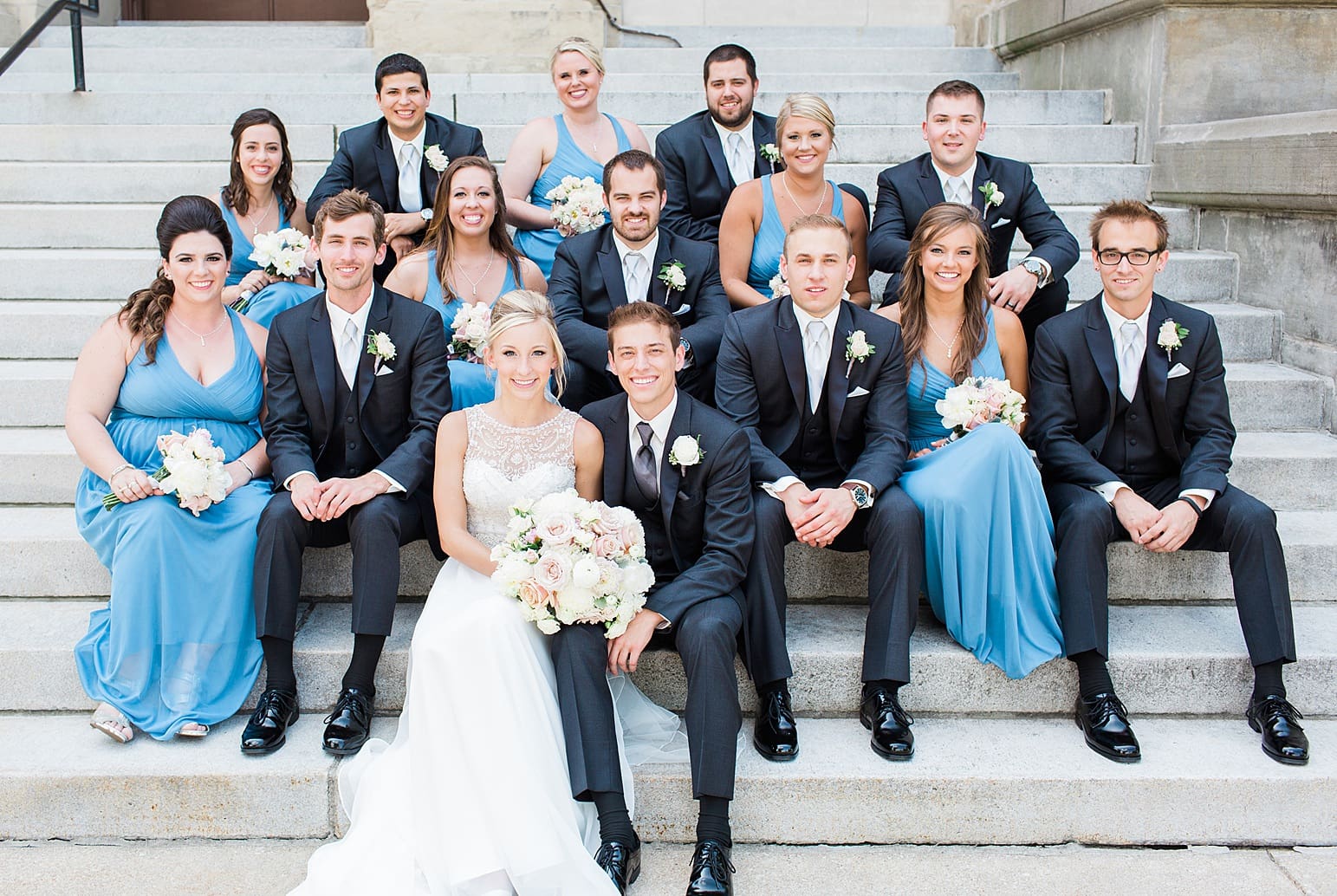 Arielle Peters Photography | Wedding party sitting on church steps on wedding day at the Spohn Ballroom in Goshen, Indiana.