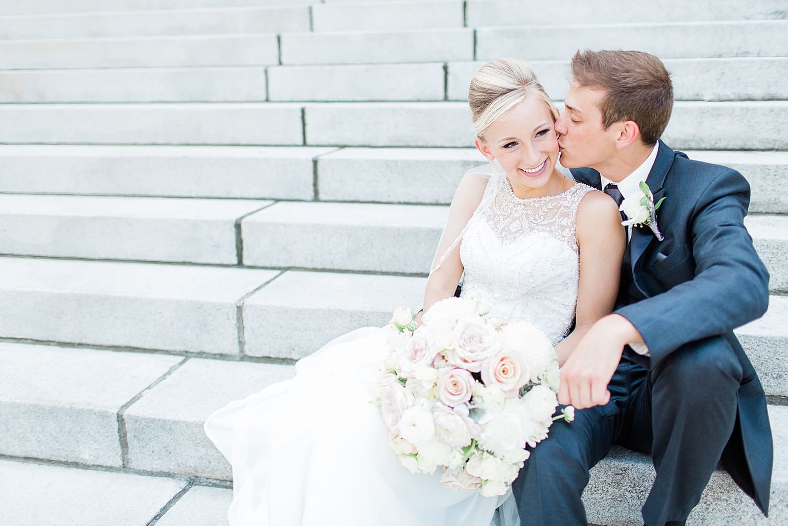 Arielle Peters Photography | Bride and groom sitting on church steps on wedding day at the Spohn Ballroom in Goshen, Indiana.