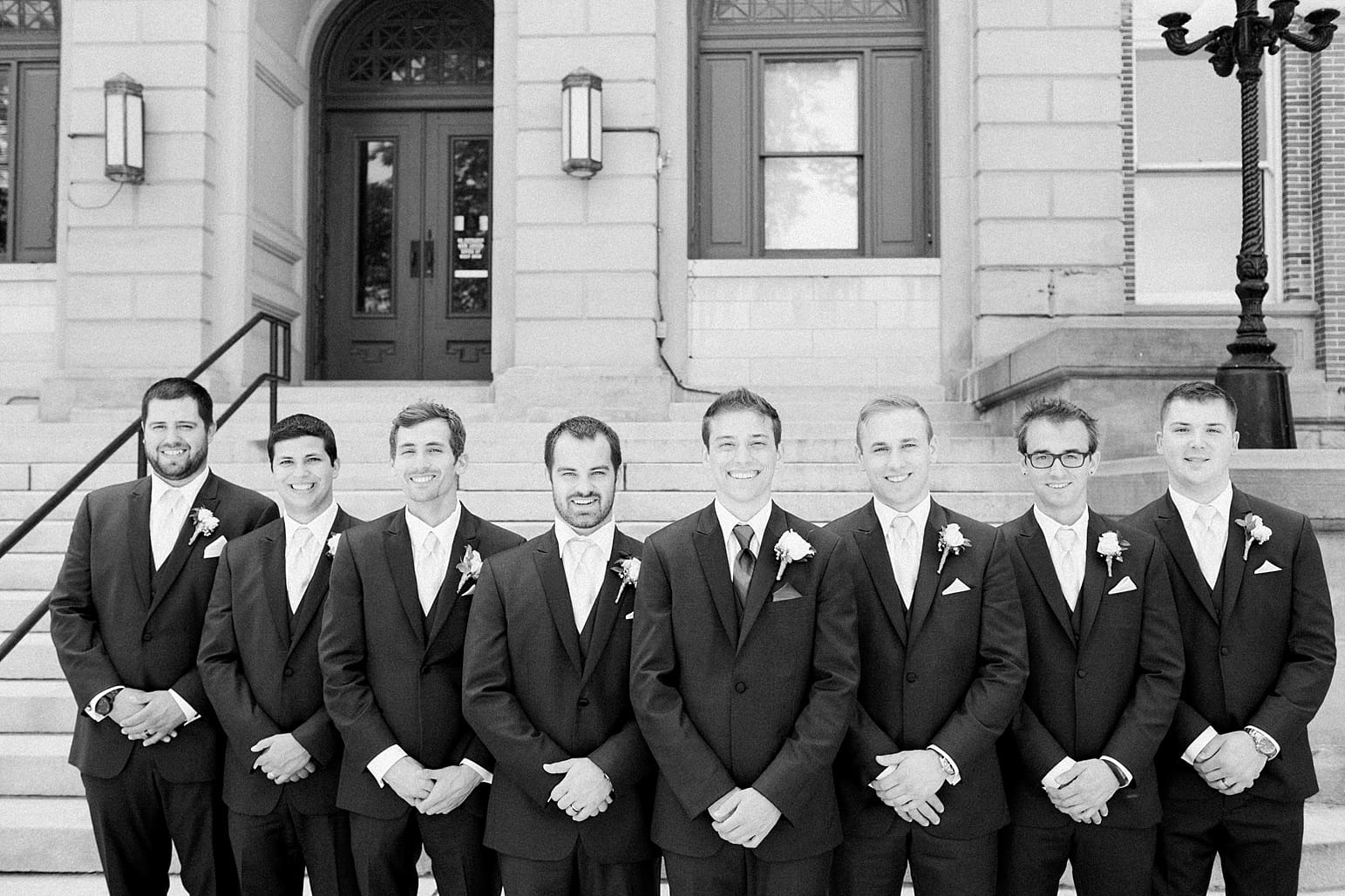 Arielle Peters Photography | Groom and groomsmen standing on church steps on wedding day at the Spohn Ballroom in Goshen, Indiana.