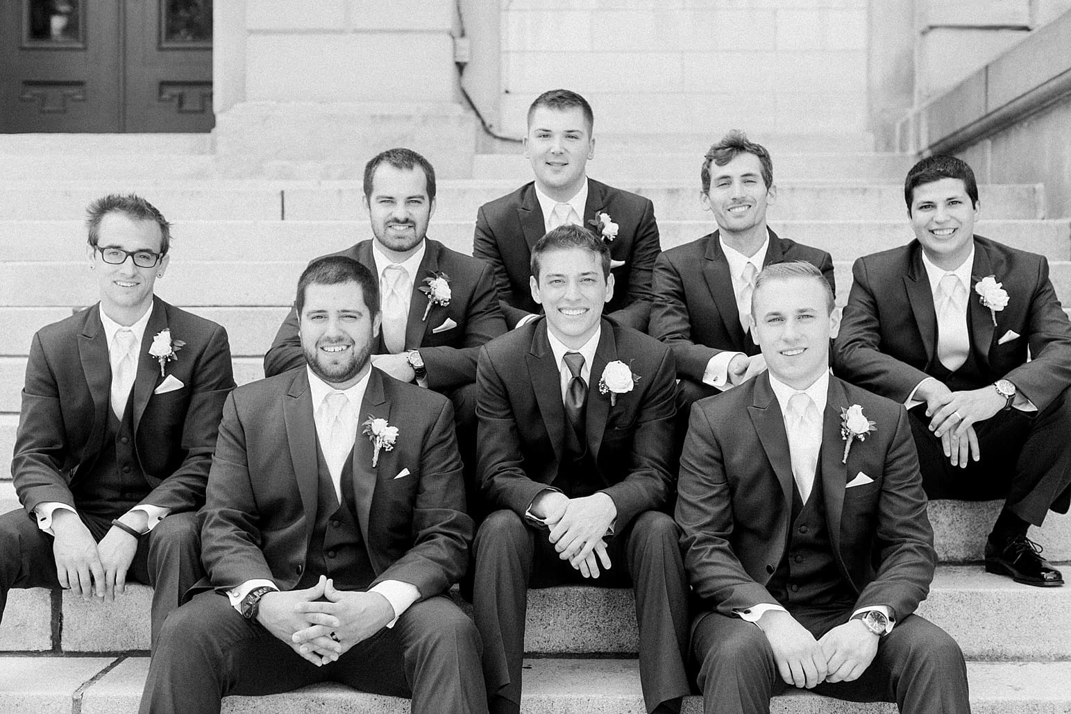 Arielle Peters Photography | Groom and groomsmen sitting on church steps on wedding day at the Spohn Ballroom in Goshen, Indiana.