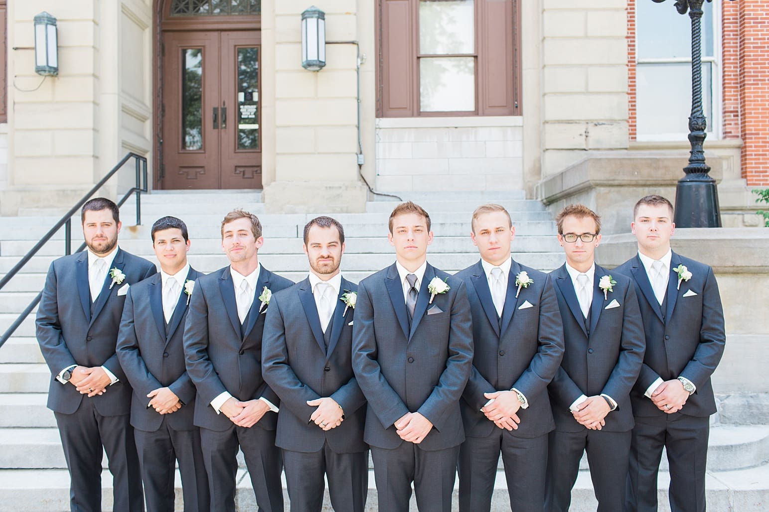 Arielle Peters Photography | Groom and groomsmen with serious faces outside the church on wedding day at the Spohn Ballroom in Goshen, Indiana.