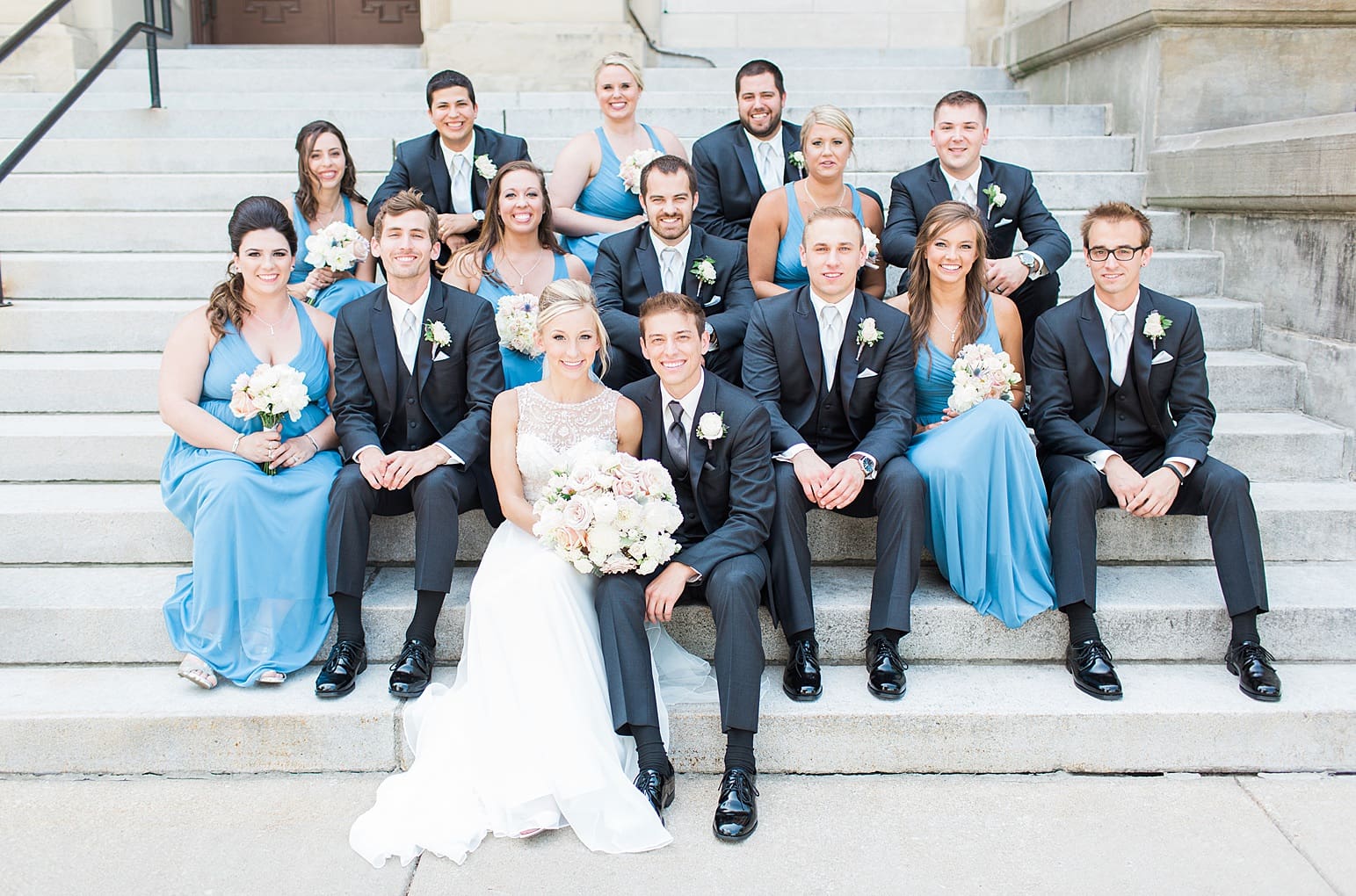 Arielle Peters Photography | Wedding party sitting on church steps on wedding day at the Spohn Ballroom in Goshen, Indiana.