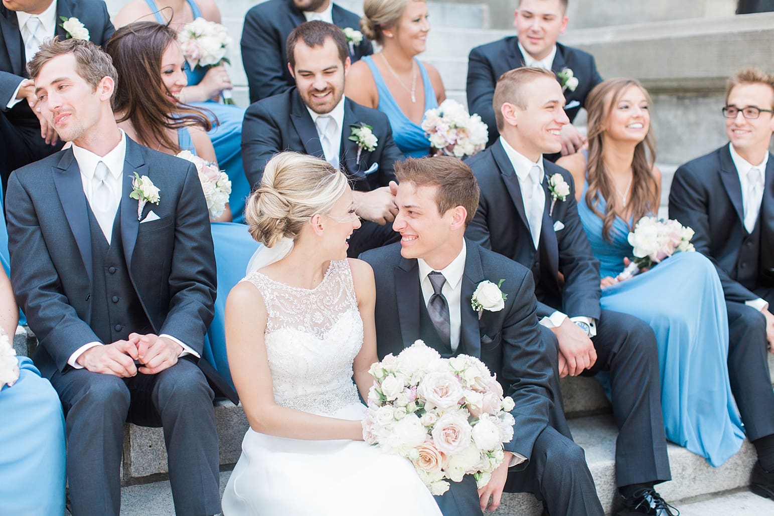 Arielle Peters Photography | Wedding party sitting on church steps on wedding day at the Spohn Ballroom in Goshen, Indiana.