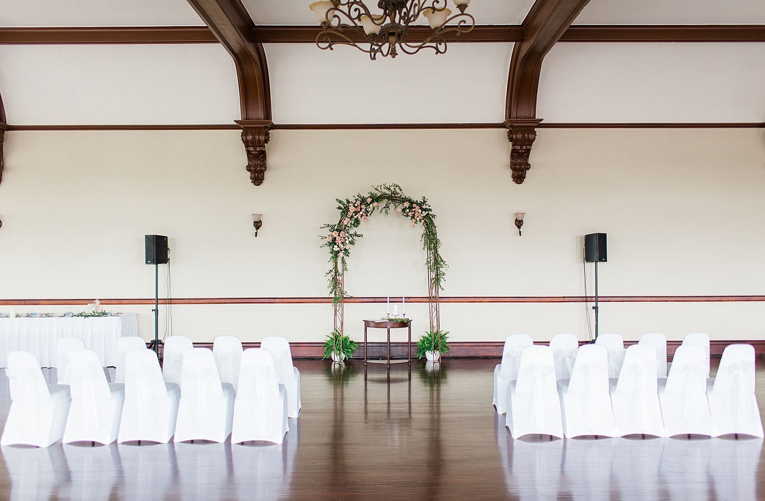 Arielle Peters Photography | Rose covered wedding arch on wedding day at the Spohn Ballroom in Goshen, Indiana.